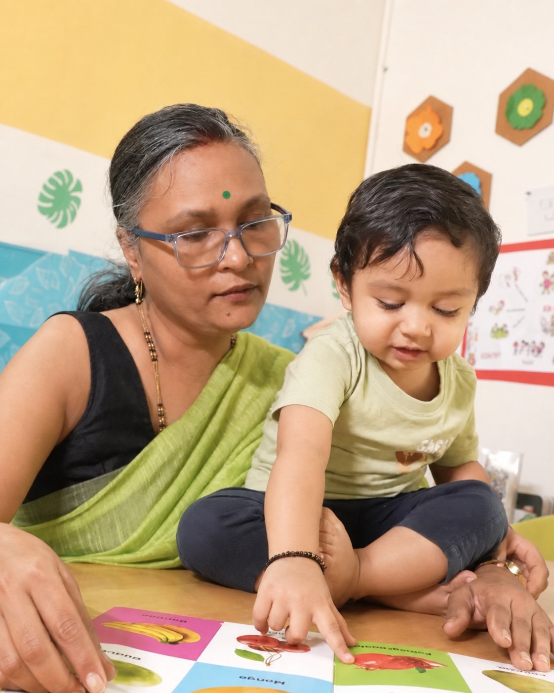 Educator and young child learning together