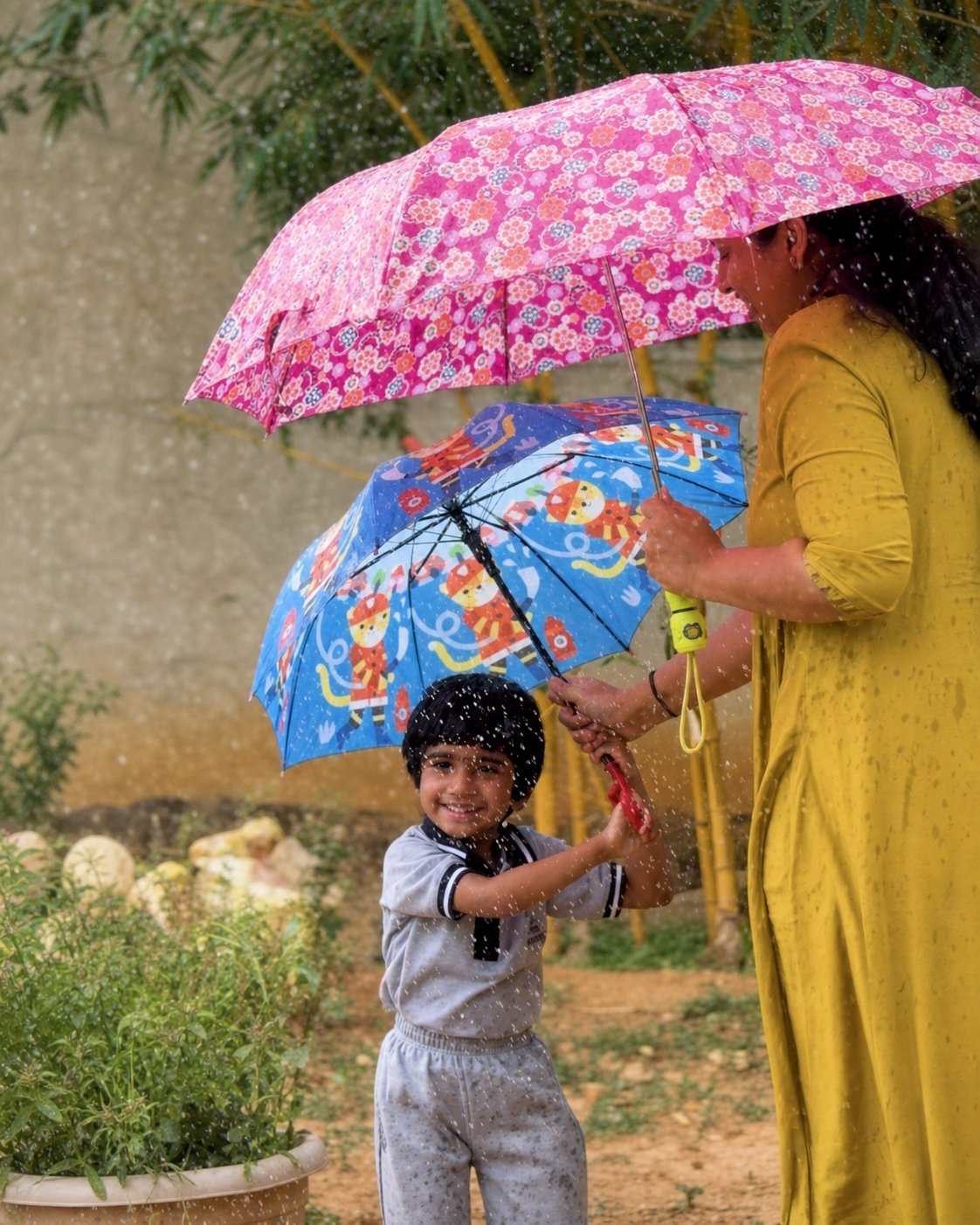Educator sharing an umbrella with a child