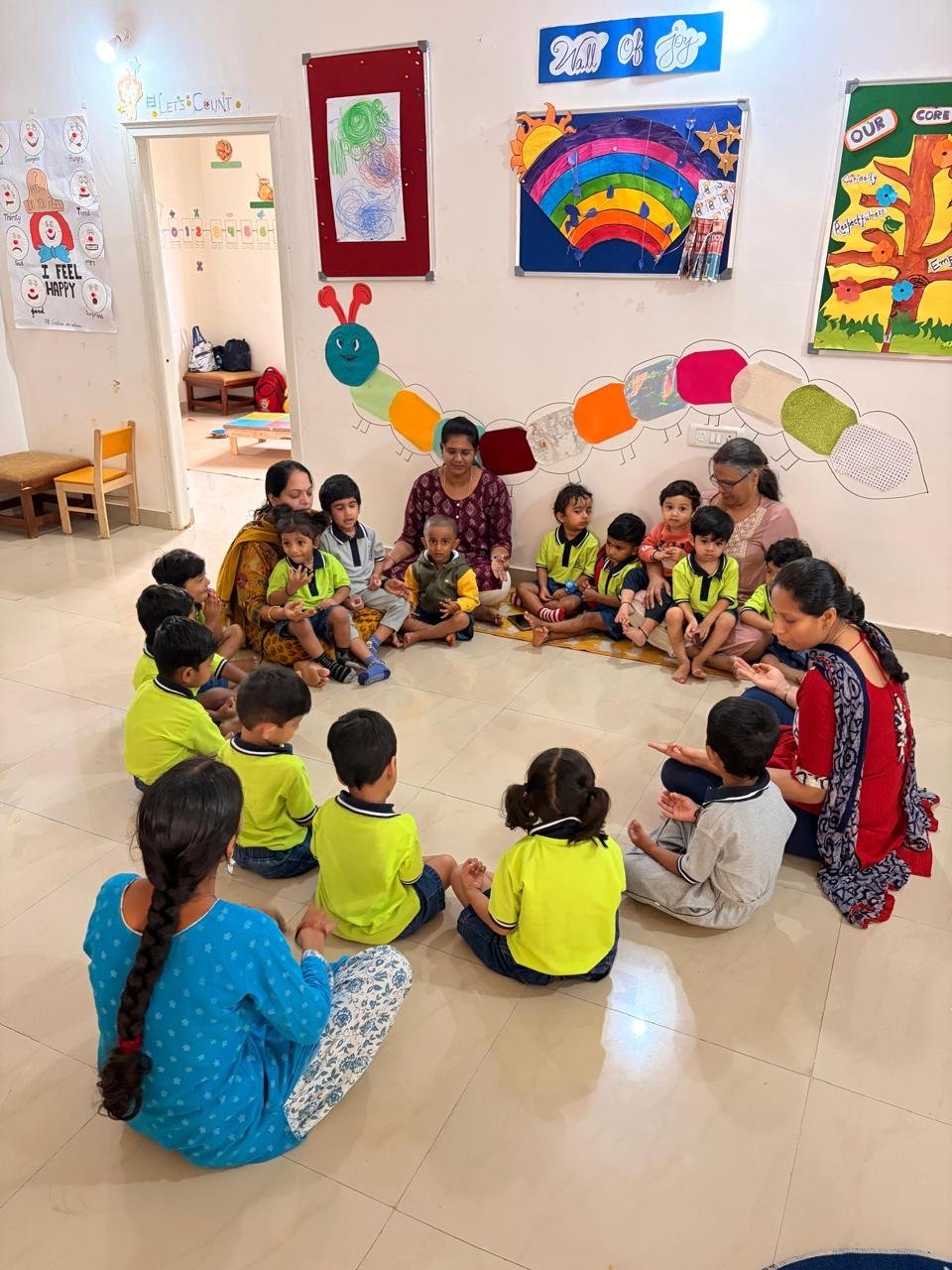 Children and educators seated together in a circle