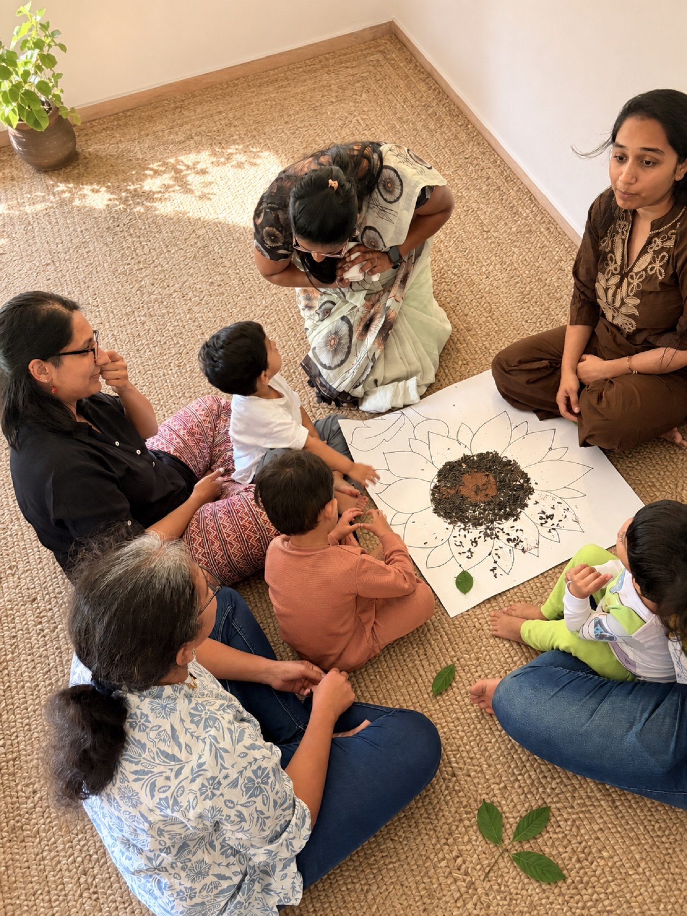 Children observing a sunflower made with soil and seeds