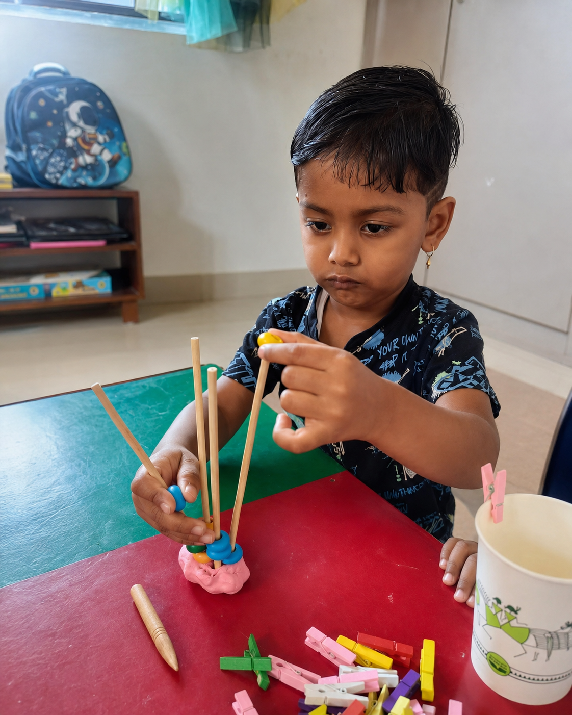 Arka child absorbed in a hands-on making activity