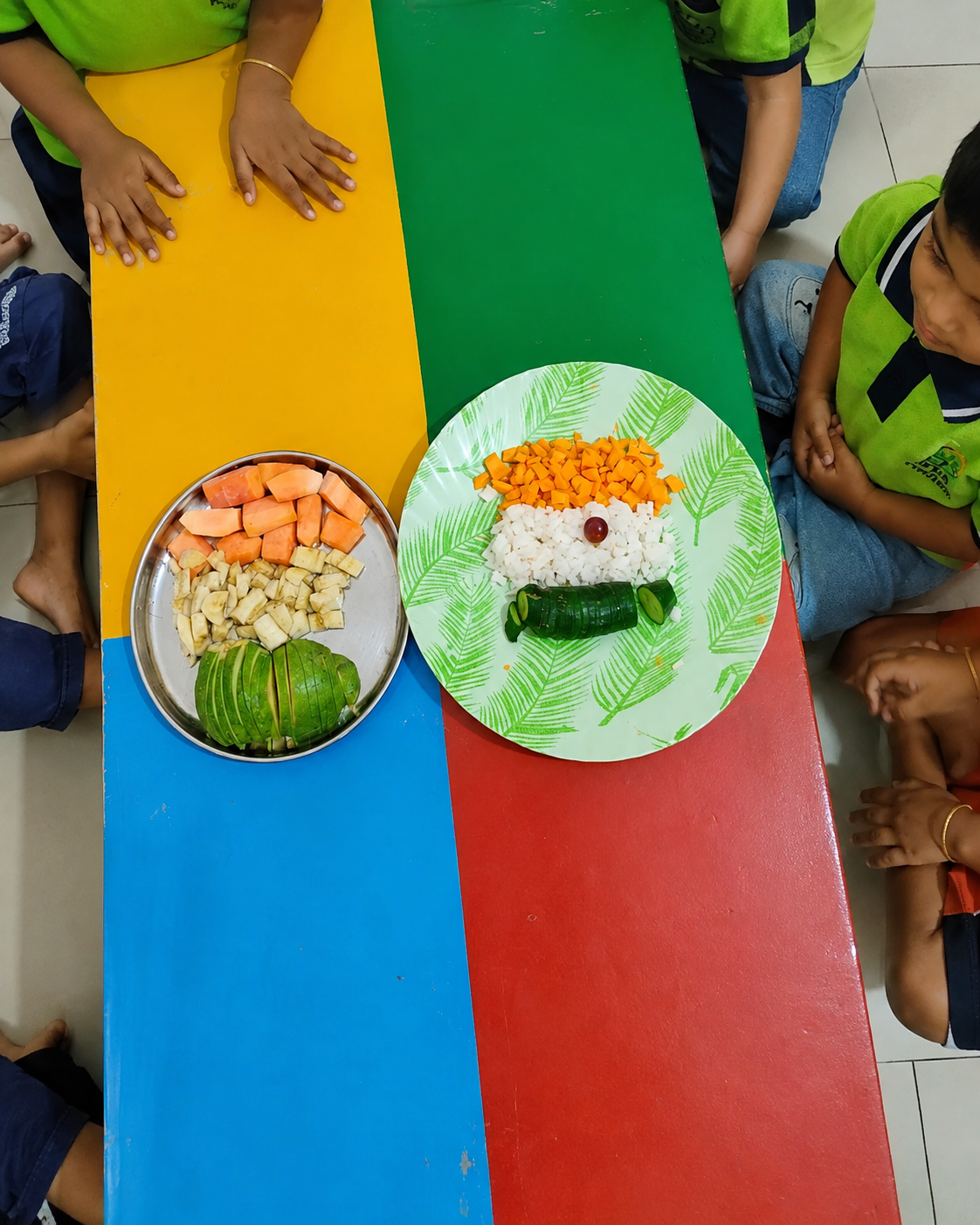 Children sharing a fruit activity at Arka