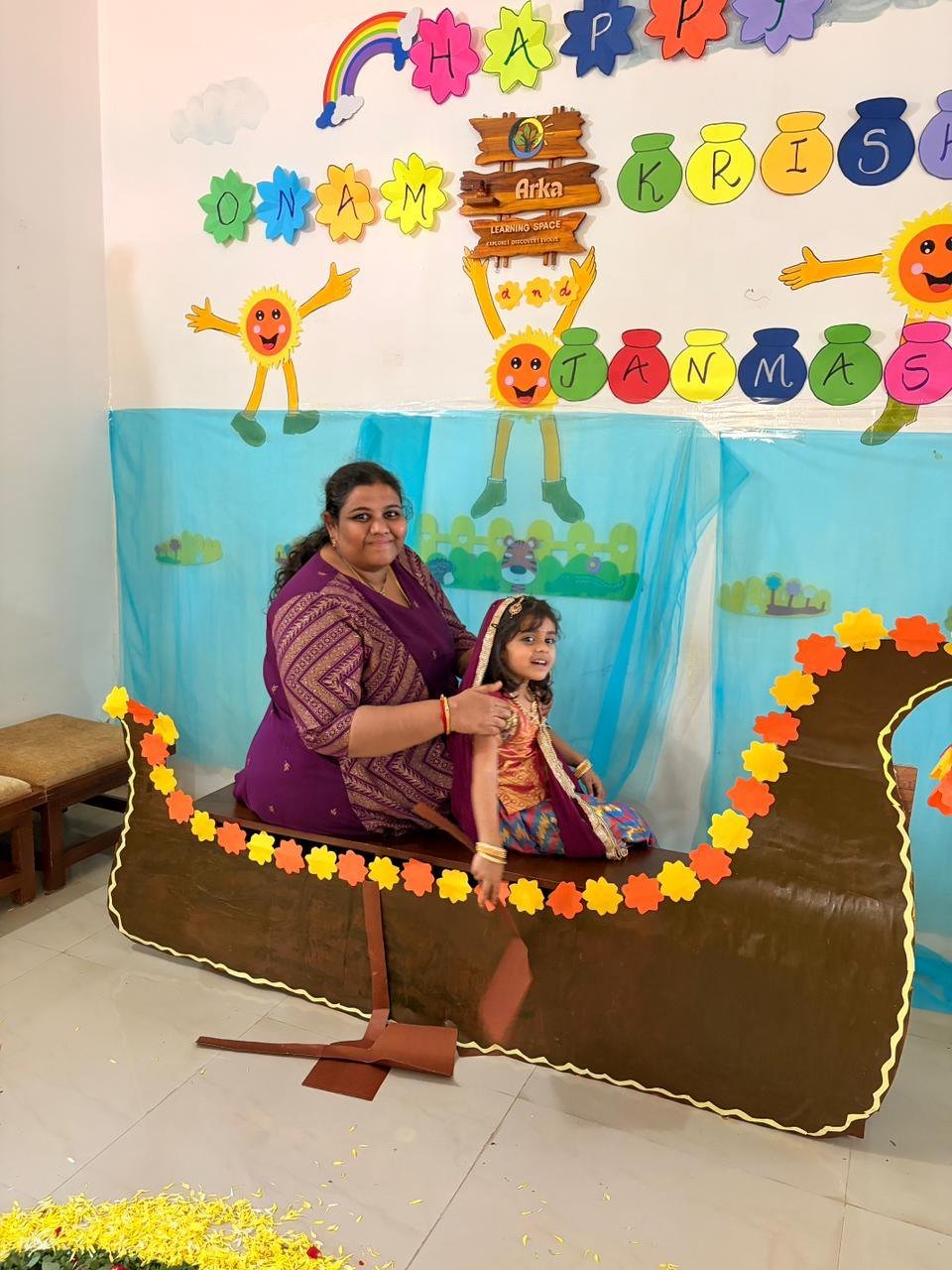 A child dressed for Krishna Janmashtami in Arka's decorated festival boat