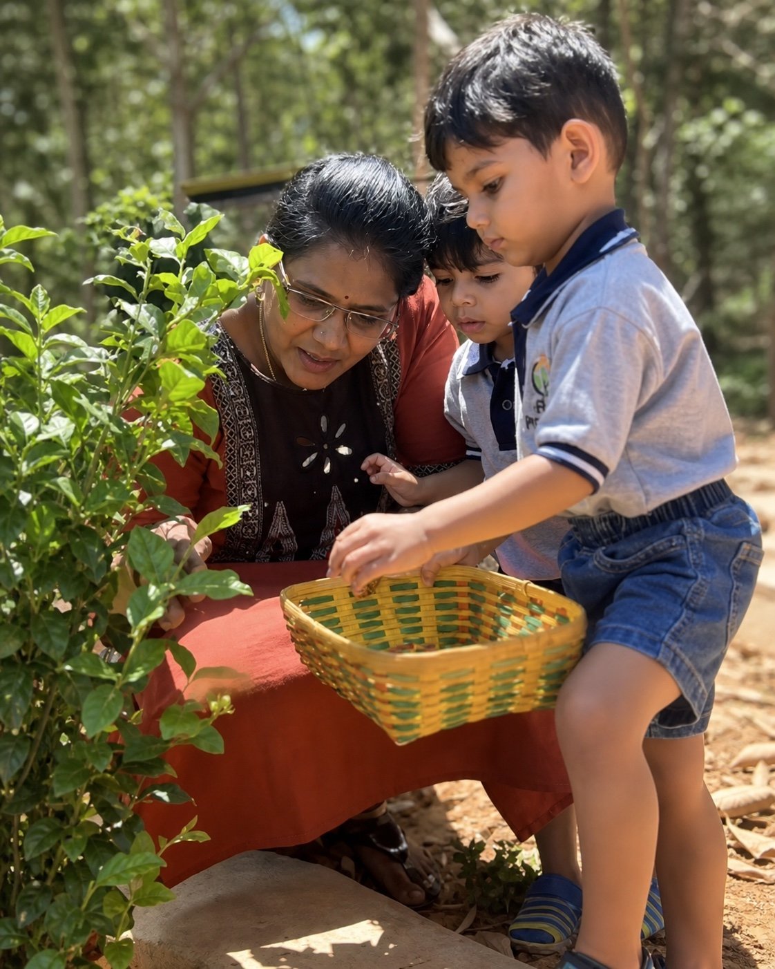 Arka educator and children noticing a garden plant