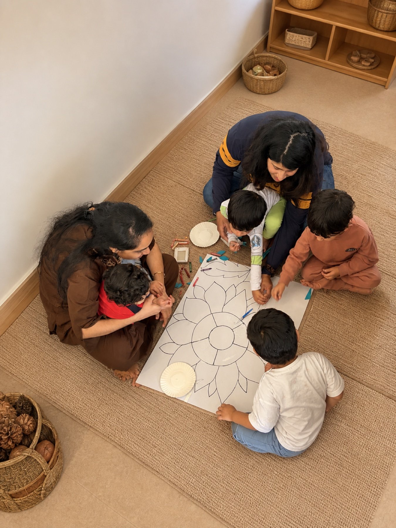 Children creating a large flower together with natural materials